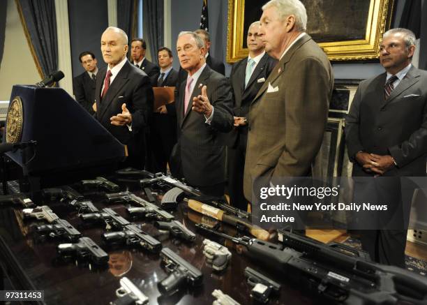 Top cop Raymond Kelly and Mayor Michael Bloomberg display weapons recovered in yesterday's bust of Florida-to-N.Y.C. Gun-trafficking gang.