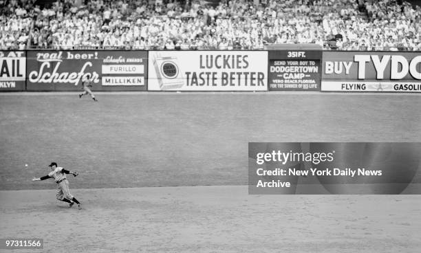 Giants shortstop Alvin Dark lunges for the ball after stopping Robinson's liner in 3d. It dropped, but he threw to second to nip Campanella.