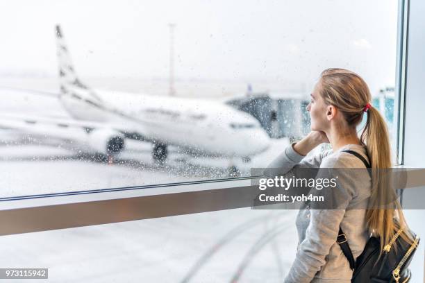 woman waiting for boarding - yoh4nn stock pictures, royalty-free photos & images