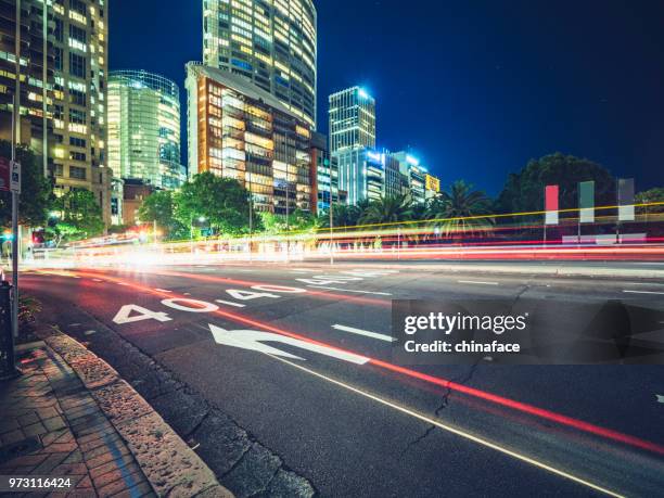 rush-hour traffic at night in downtown sydney - sydney road stock pictures, royalty-free photos & images