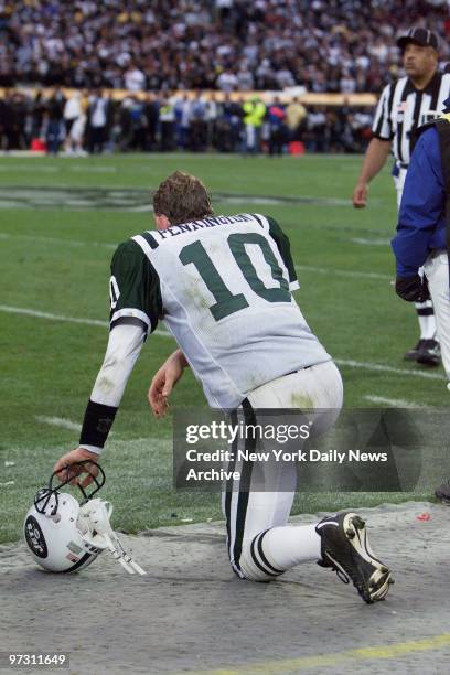 New York Jets' quarterback Chad Pennington kneels on the sidelines late in the fourth quarter of the AFC divisional playoff game against the Oakland...