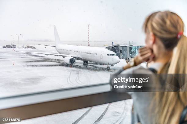 young woman waiting for boarding - bad weather on window stock pictures, royalty-free photos & images