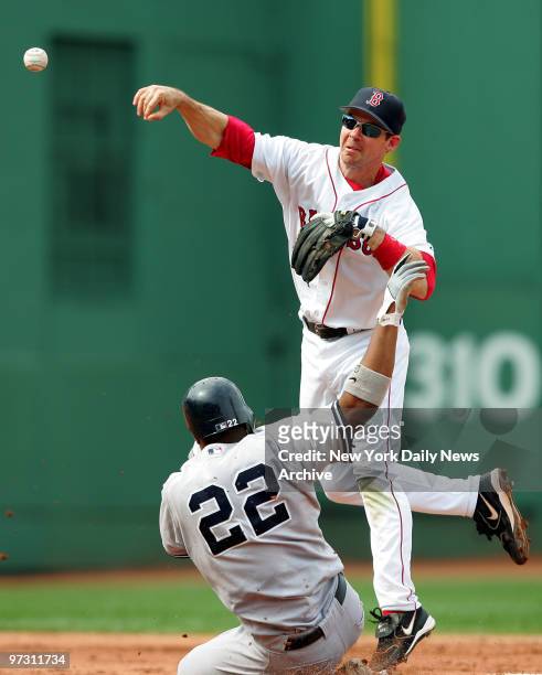 New York Yankees' Robinson Cano is out at second, but breaks up a double-play throw by Boston Red Sox's second baseman Mark Loretta during the fifth...