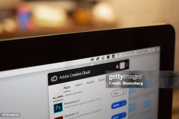 The Adobe Systems Inc. Creative Cloud application manager window is displayed on a computer monitor in an arranged photograph taken in Tiskilwa,...