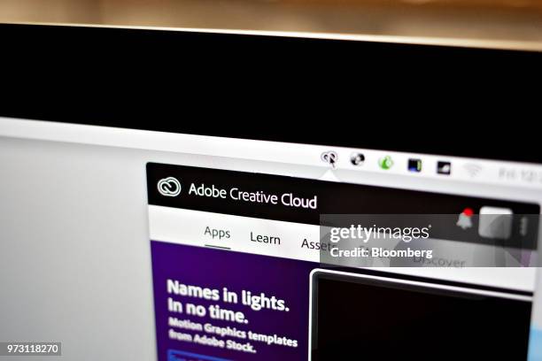 The Adobe Systems Inc. Creative Cloud software application manager window is displayed on a computer monitor in an arranged photograph taken in...