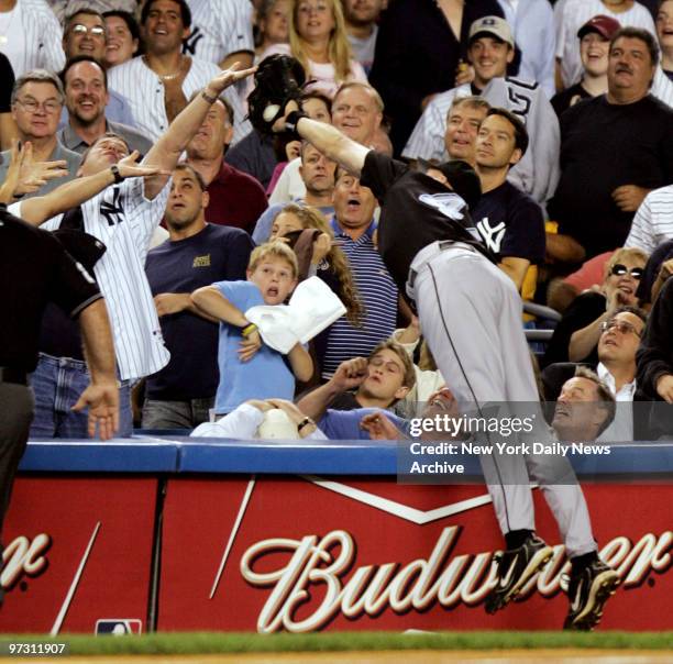Toronto Blue Jays' Corey Koskie dives for a foul ball hit by New York Yankees' Gary Sheffield to end the third inning. Toronto won, 9-5, at Yankee...
