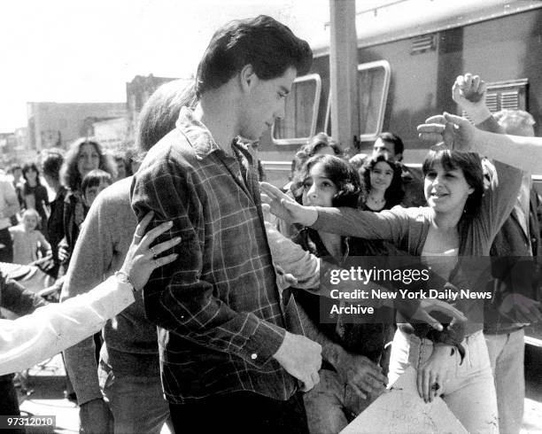 John Travolta, star of TV series "Welcome Back, Kotter" tries to make his way through crowd of fans for lunch break in Brooklyn. Travolta is working...