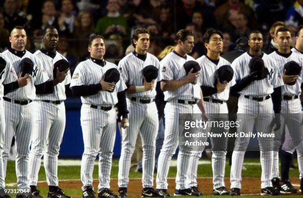 New York Yankees' Roger Clemens, Jose Contreras, Karim Garcia, Aaron Boone, Jason Giambi, Hideki Matsui, Bernie Williams and Derek Jeter holds their...