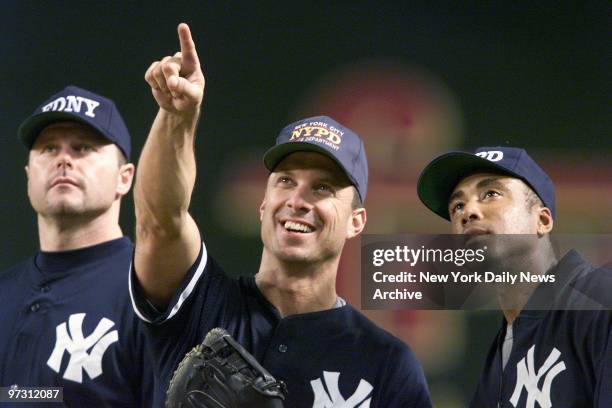 New York Yankees' Roger Clemens, Tino Martinez and Bernie Williams get together during practice at Bank One Ballpark in Phoenix, Ariz., on the day...