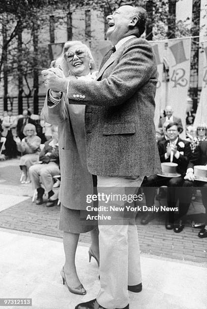 Ginger Rogers and Mayor Ed Koch dance and have a laugh on 42nd St.