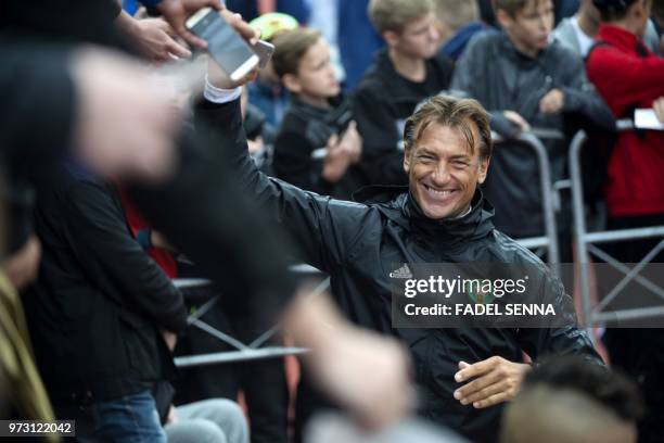 Moroccan' coach Herve Renard signs autographs smiles as he speaks with fans greeting him at the end of a training session of the Moroccan national...