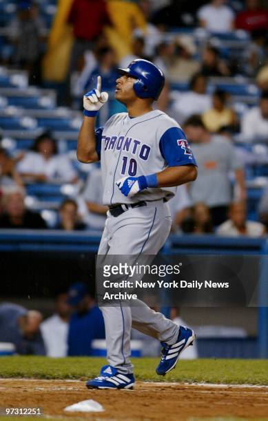 Toronto Blue Jays' Vernon Wells points upstairs as he crosses the plate after hitting a solo homer in the eighth inning against the New York Yankees....