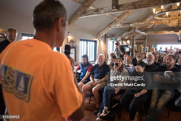 Sir Robin Knox-Johnston listens as people speak at a press conference in the Chain Locker public house besides the harbour in Falmouth on June 13,...