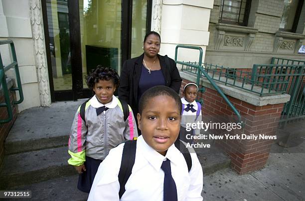 Johnny Menzies sets off for school as his mother, Jacqueline, and sisters, Fatisha and Lillian 5, look on. The 11-year-old boy attends the Bronx...