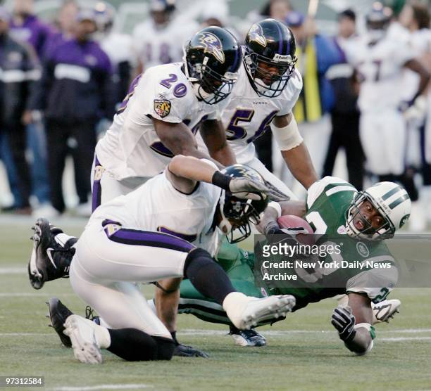 New York Jets' running back Curtis Martin is brought down by the Baltimore Ravens' defense in fourth-quarter action at Giants Stadium. The Ravens...