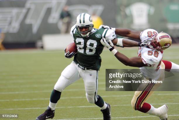 New York Jets' running back Curtis Martin keeps a San Francisco 49ers defender at a safe distance in a game at Giants Stadium. Martin racked up 111...