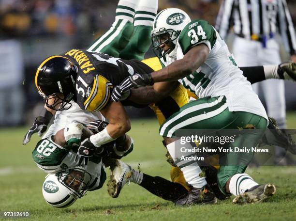 New York Jets' running back Curtis Martin lands on his head as he's hit by Pittsburgh Steelers' linebacker James Farrior during the first half of an...