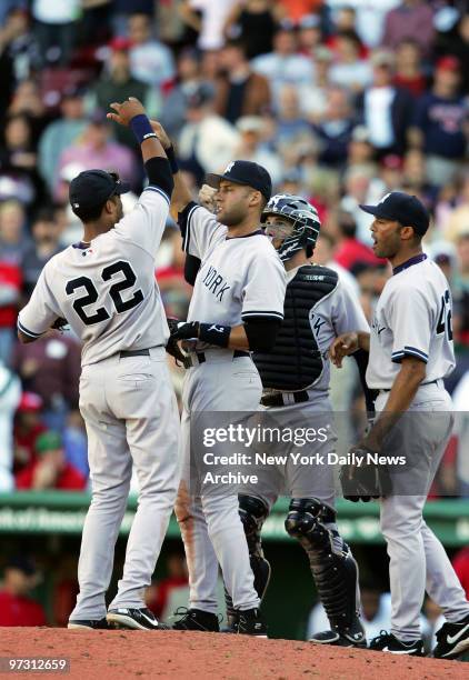 New York Yankees' second baseman Robinson Cano, shortstop Derek Jeter, catcher John Flaherty and closer Mariano Rivera celebrate on the mound after...