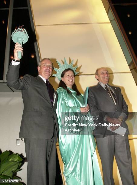 Mayor Michael Bloomberg takes hold of Miss Liberty's torch at the opening of the Westin New York at Times Square on W. 43rd St. And Eighth Ave. They...