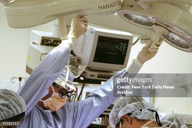 Surgeon Dr. Mark Galantowicz directs lights during open-heart surgery on Maria Lucia Miller at Columbia-Presbyterian Babies and Children's Hospital...