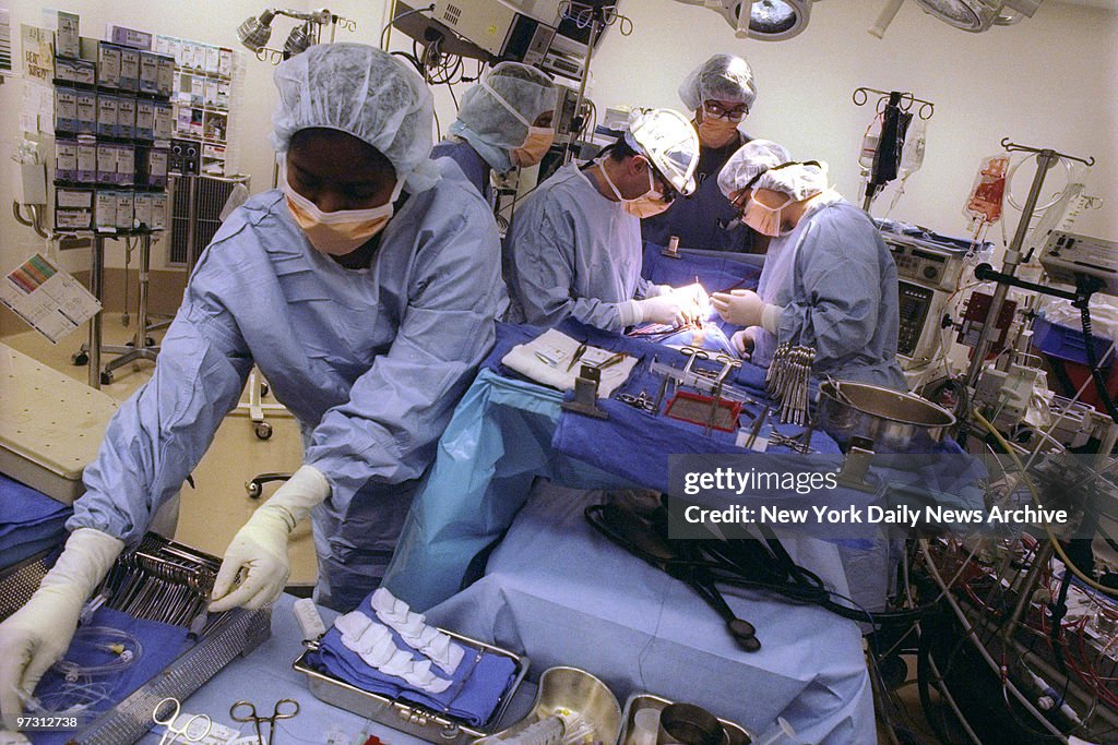 Surgical nurse Verna Liverpool-Paul (foreground) readies ins
