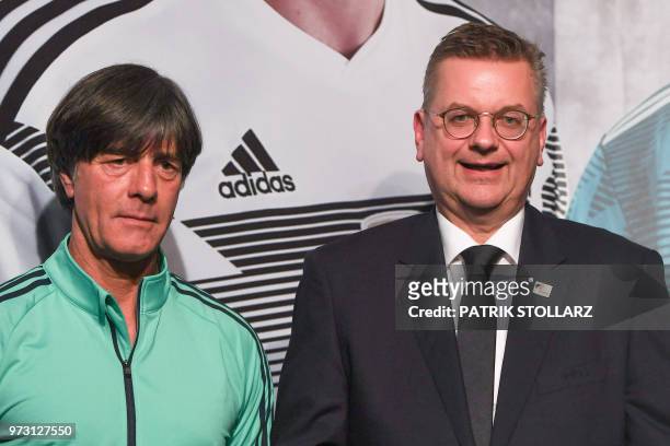 President of the German Football Association Reinhard Grindel , flanked by Germany's coach Joachim Loew , speaks during a press conference, in...