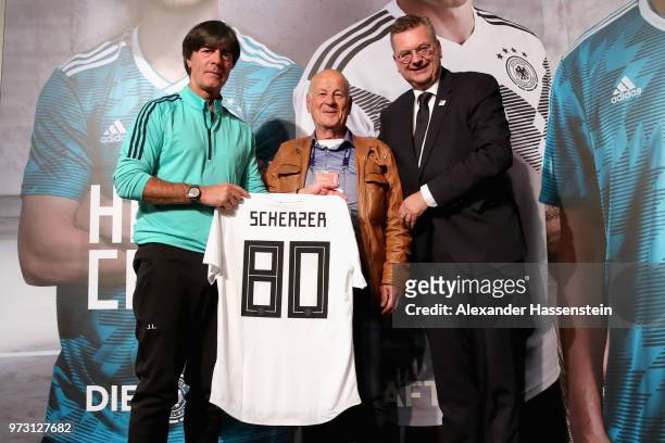 Joachim Loew, head coach of Germany hand-over a Germany match jersey with Reinhard Grindel , President of the German National Football Federation to...