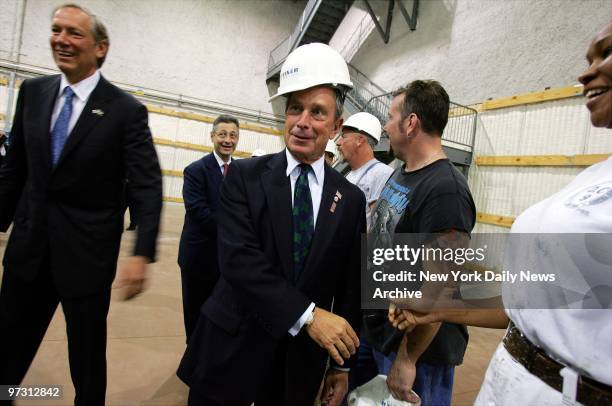 Mayor Michael Bloomberg tries on a construction hat as he greets workers at Steiner Studios, a new Hollywood-style production studio on the site of...