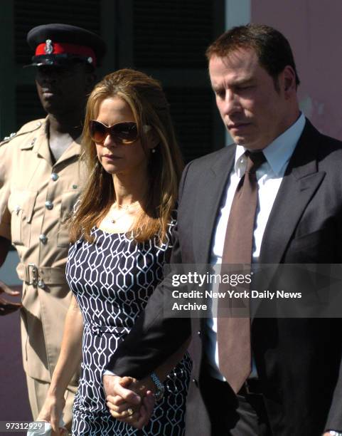 John Travolta's Extortion Case in Nassau Bahamas Supreme Court. John Travalta and his wife Kelly Preston surrounded by a phalanx of security leaving...