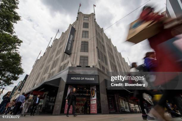 Pedestrians pass a House of Fraser store, one of the stores slated for closure, on Oxford Street, in central London, U.K., on Wednesday, June 13,...