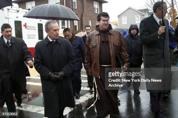 Mayor Michael Bloomberg, a Franciscan friar and Gov. George Pataki walk to St. Francis' Church from the spot where American Airlines Flight 587...