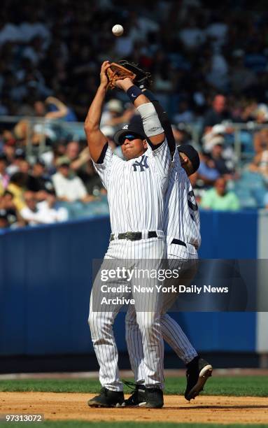 New York Yankees' shortstop Derek Jeter and third baseman Alex Rodriguez both fail to catch a pop fly in the sixth inning of a game against the...