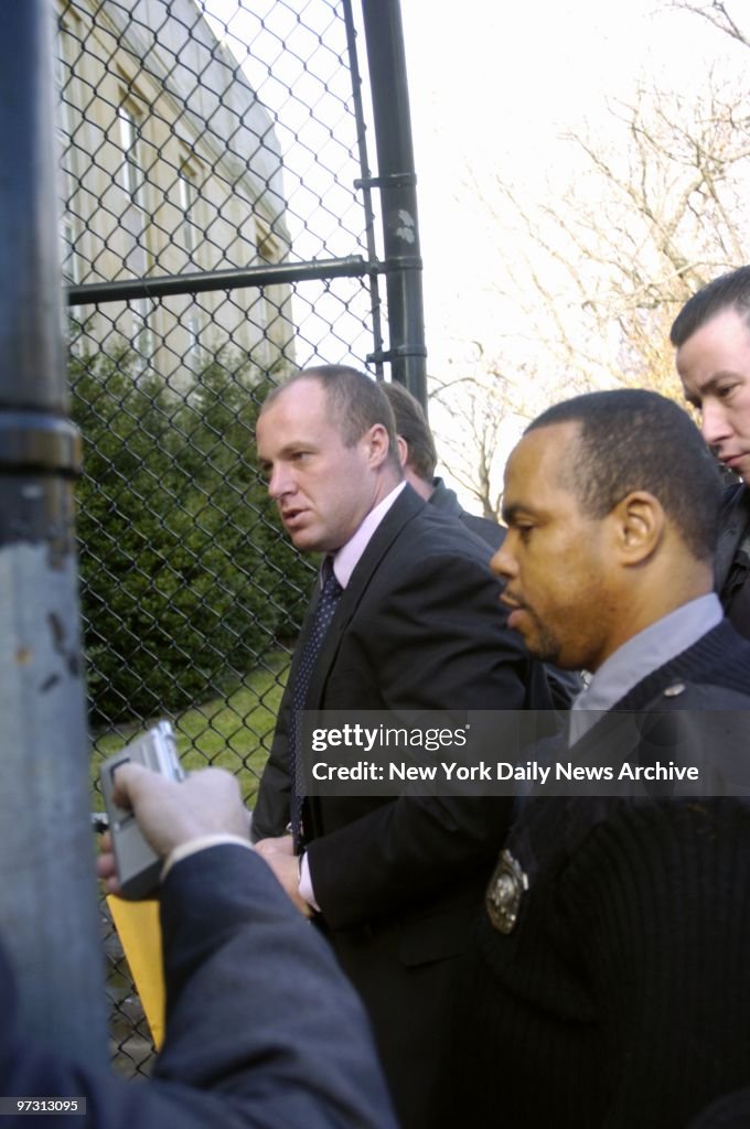 David Malone (left) is escorted into Nassau County Court in