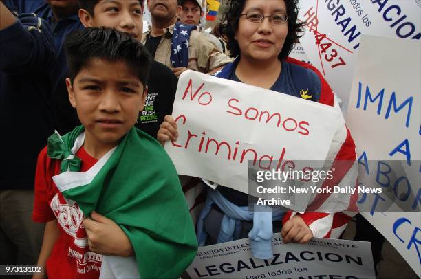 Demonstrators carry signs and the flags of their homelands as thousands of legal and undocumented immigrants - and their supporters - stream over the...