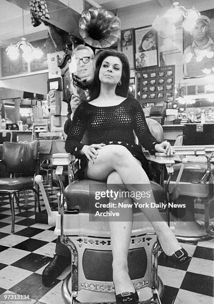 Helena Jackman gets her hair cut with a flame torch by barber Paul Mole, who claims to be the only master of the flame cut.