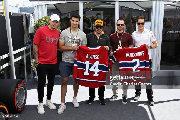 Fernando Alonso of Spain and McLaren F1 and Stoffel Vandoorne of Belgium and McLaren F1 swap shirts with hockey players, including Hampus Lindholm of...