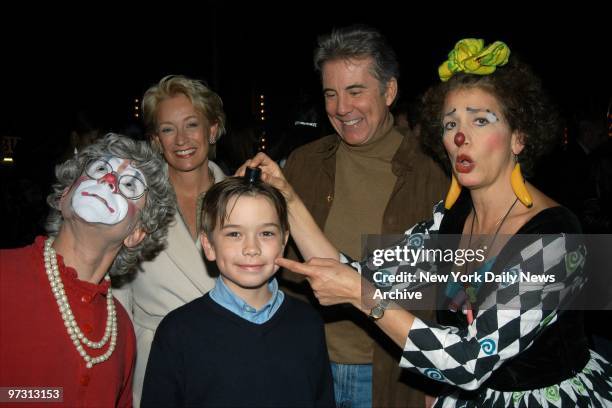John Walsh, wife Reve and son Hayden have some fun with clowns Grandma and Hilary during the Big Apple Circus' opening night gala at the Big Top Tent...