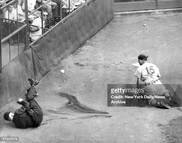 St. Louis Cardinals' catcher Bill Sarni looks toward plate umpire Art Gore after the two collided while Sarni was giving chase to a foul pop by the...