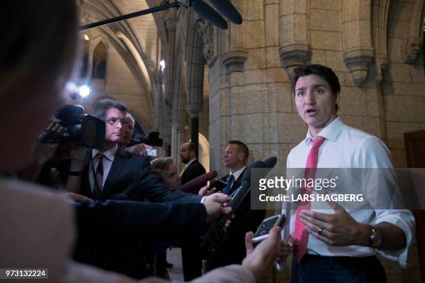 Canadian Prime Minister Justin Trudeau speaks with the media on Parliament Hill in Ottawa, Ontario on June 13, 2018. - The 2026 World Cup hosted by...