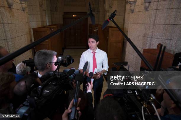 Canadian Prime Minister Justin Trudeau speaks with the media on Parliament Hill in Ottawa, Ontario on June 13, 2018. - The 2026 World Cup hosted by...