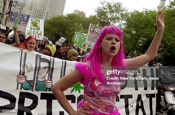 Tracy Blevins, known as the Medical Marijuana Barbie, leads a group of marchers past City Hall protesting laws criminalizing marijuana use. Thirty...