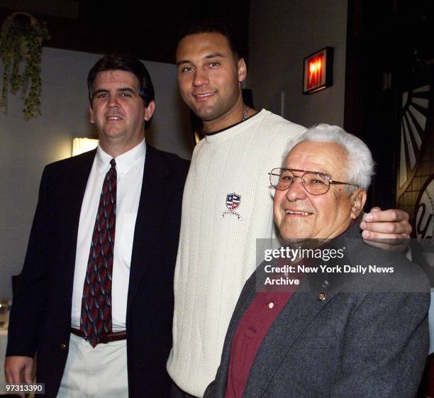 New York Yankees shortstop Derek Jeter is flanked by Les Bowler of South Hadley, Mass., and John Leal of Fresno, Calif., at the Yankee Club in Yankee...