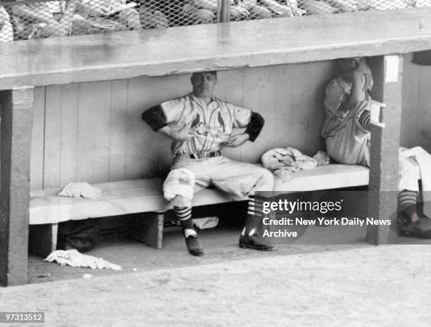 St. Louis Cardinals' manager Ed Stanky sits in dugout with a towel wrapped around his knee and mocks the Dodgers' Jackie Robinson after Robinson...