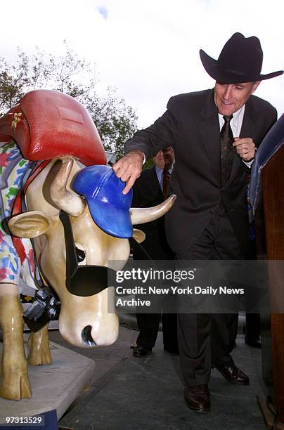 Mayor Rudolph Giuliani, wearing a cowboy hat, at a press conference in City Hall Park to announce the launch of Cow Parade, set to arrive in New York...