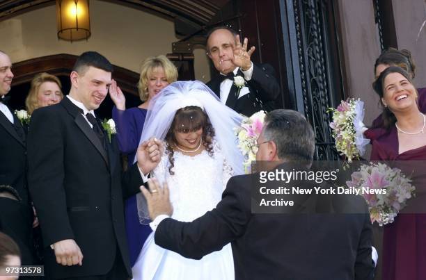 Mayor Rudy Giuliani throws confetti after the wedding of New York City Police Officer Michael Ferrito and Diane Gorumba at St. James Lutheran Church...