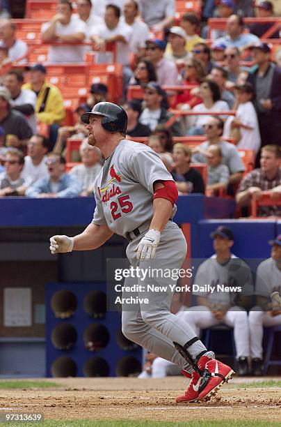 St. Louis Cardinals' Mark McGwire watches his 49th home run of the season sail over the right-centerfield fence off New York Mets' starting pitcher...