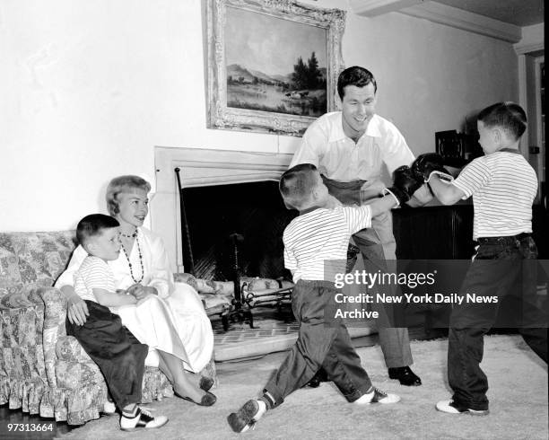 Johnny Carson and his family at his home, Birch Hill Estate, Winfield Ave, Harrison, N.Y. Time for roughhousing, Johnny takes on both Kit and Ricky...