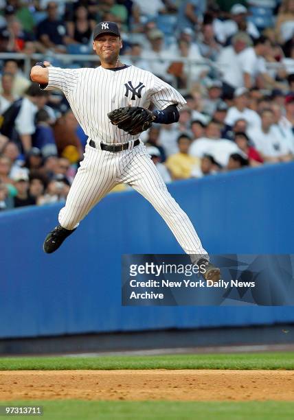 New York Yankees' shortstop Derek Jeter makes a leaping throw to first but Tampa Bay Devil Rays' Julio Lugo is safe at the base during the fifth...