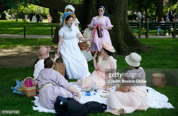 Antonia Pugliese of Medford, center, says hello to friends as she arrives at the Boston Historical Costumers Picnic at the Boston Public Garden on...
