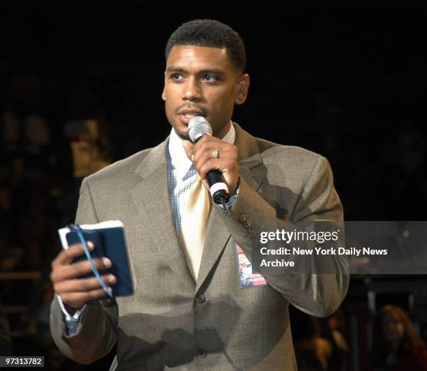 New York Knicks' Allan Houston holds a prayer book and speaks during "A Tribute to Grace and Hope" at Madison Square Garden on the first anniversary...